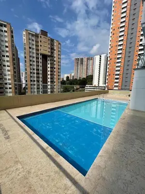 a blue swimming pool on the roof of a building at Amplio y acogedor Apartamento en Sabaneta cerca al parque in Sabaneta