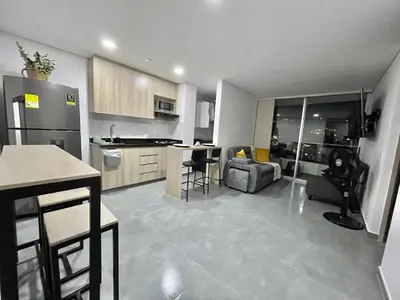 a kitchen and living room with a couch and a table at Amplio y acogedor Apartamento en Sabaneta cerca al parque in Sabaneta