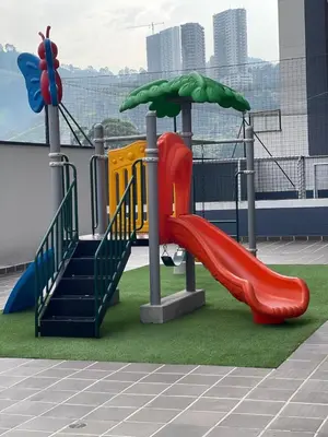 a playground with a red slide and stairs on a building at Amplio y acogedor Apartamento en Sabaneta cerca al parque in Sabaneta