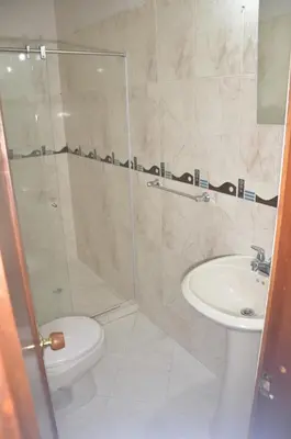 a bathroom with a shower and a toilet and a sink at Apto Amoblado 3 Hab Cerca al Atanasio in Medellín