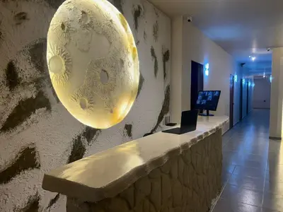 a large mask hanging on a wall in a room at Hotel Kyros by 70 in Medellín