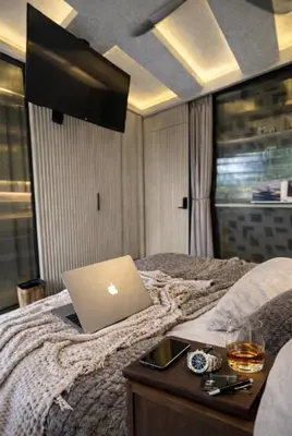 a laptop computer sitting on top of a bed at CEMNTUS VILLA , Rooftop Jacuzzi, 9BR, VIP Service in Medellín