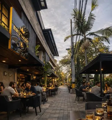 a group of people sitting at tables outside a restaurant at CEMNTUS VILLA , Rooftop Jacuzzi, 9BR, VIP Service in Medellín