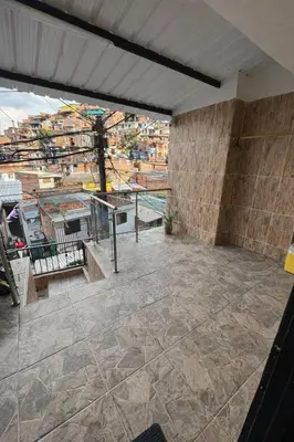 a patio with a table and a view of a city at House with Terrace San Javier Comuna 13 in Medellín