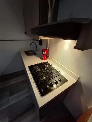 a stove top oven with a pot on top of it at Baires Loft Apatartamentos in Medellín