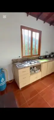 a kitchen with a stove and a window at Casa de piedra #35 in San Rafael