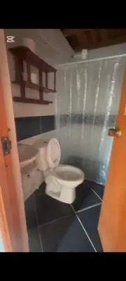 a bathroom with a white toilet and a sink at Casa de piedra #35 in San Rafael