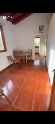 a living room with a wooden floor and a table and chairs at Casa de piedra #35 in San Rafael