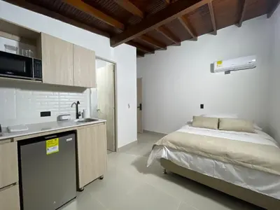 a kitchen with a bed and a sink in a room at Living Yellow in Alpujarra