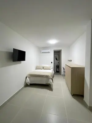 a bedroom with a bed and a flat screen tv at Living Yellow in Alpujarra