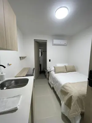 a bathroom with a bed and a sink in a room at Living Yellow in Alpujarra