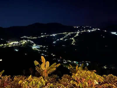 a view of a city at night at Kamalú Glamping in Medellín