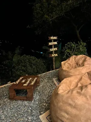 a wooden bench sitting next to two bean bags at Kamalú Glamping in Medellín