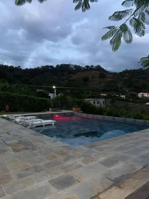 a swimming pool with two lounge chairs in it at Finca en Sopetran con Piscina lnfinita y Jacuzzi in Sopetran