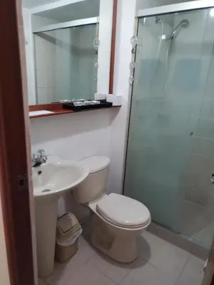 a bathroom with a toilet and a sink and a shower at Habitación en el poblado in Medellín
