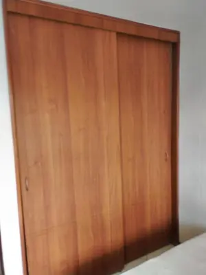 a large wooden door in a room at Habitación en el poblado in Medellín