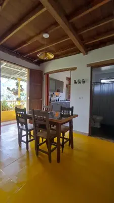 a dining room with a wooden table and chairs at Casa Madreselva in Jardin
