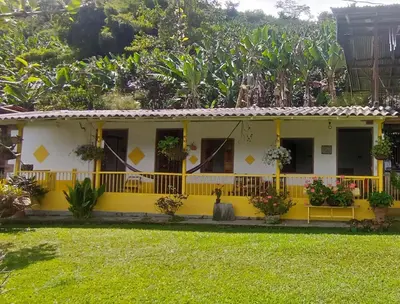 a yellow house with a yellow fence at Casa Madreselva in Jardin