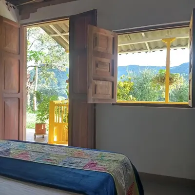 a bedroom with a bed and a large window at Casa Madreselva in Jardin