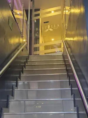 an escalator in a building with stairs in front at Hotel bastilla real in Medellín