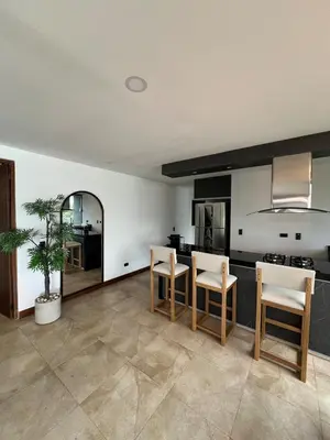 a kitchen with a table and chairs in a room at Cabaña en Guatapé in Guatapé
