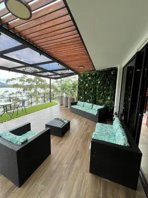 a living room with two couches and a patio at Cabaña en Guatapé in Guatapé