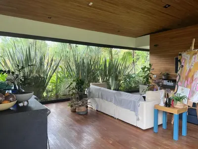 a living room with a white couch and some plants at Beautiful house in nature minutes from Medellín in El Retiro