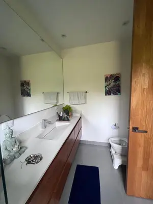 a bathroom with two sinks and a toilet at Beautiful house in nature minutes from Medellín in El Retiro