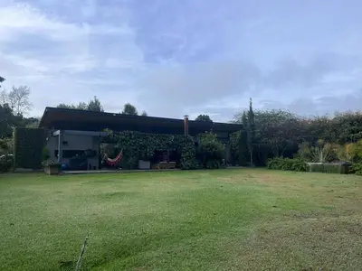 a house with a large yard in front of it at Beautiful house in nature minutes from Medellín in El Retiro