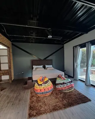 a bedroom with a bed and two pillows on the floor at Hotel Elixer Habitat in Santa Rosa de Cabal
