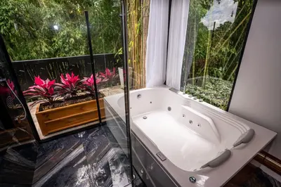 a bath tub in a bathroom with a window at Hotel Elixer Habitat in Santa Rosa de Cabal