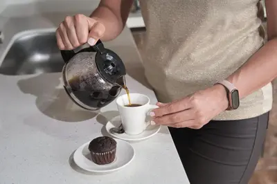 a woman is pouring coffee into a cupcake at Hotel Elixer Habitat in Santa Rosa de Cabal