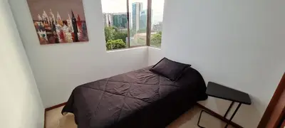 a small bedroom with a bed and a window at Balsos de oviedo in Medellín