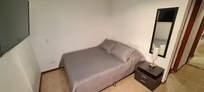 a small bed in a room with a mirror at Balsos de oviedo in Medellín