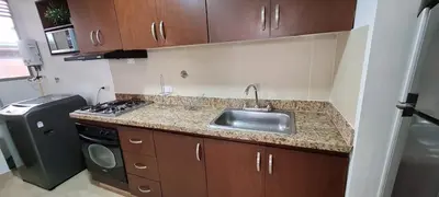 a small kitchen with a sink and a stove at Balsos de oviedo in Medellín