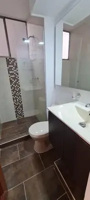 a bathroom with a toilet and a sink and a shower at Balsos de oviedo in Medellín