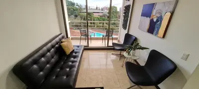 a living room with a couch and chairs and a pool at Balsos de oviedo in Medellín