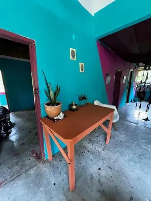 a wooden table in a room with a blue wall at Refugio salvaje in San Rafael