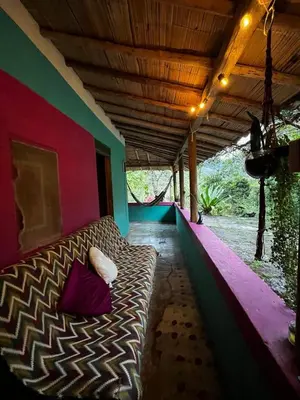 a couch sitting on a porch with avertisement at Refugio salvaje in San Rafael