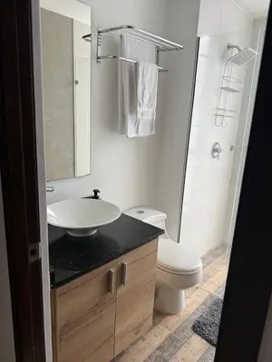 a bathroom with a sink and a toilet and a mirror at Studio apartment in El Poblado next to Oviedo Mall in Medellín