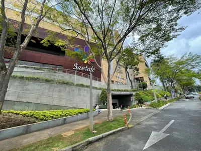 a building with a sign on the side of a street at Studio apartment in El Poblado next to Oviedo Mall in Medellín