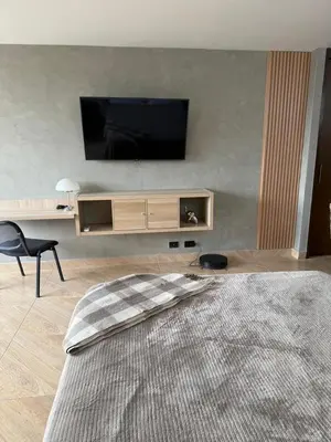 a living room with a flat screen tv on a wall at Studio apartment in El Poblado next to Oviedo Mall in Medellín