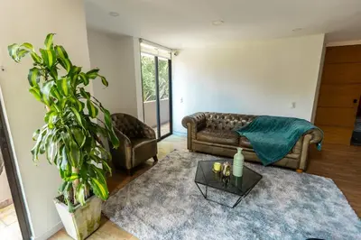 a living room with a couch and a table at Duplex First laureles park in Medellín