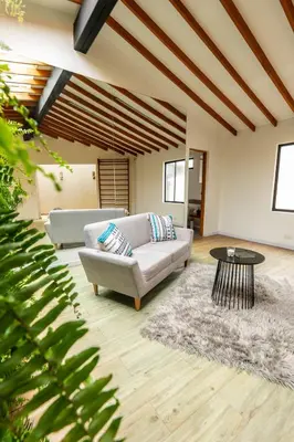 a living room with a couch and a table at Duplex First laureles park in Medellín