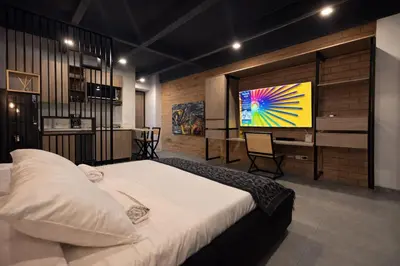 a bedroom with a large bed and a television at Loft de lujo en Laureles in Medellín