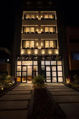 a tall building with lights on it at night at Loft de lujo en Laureles in Medellín