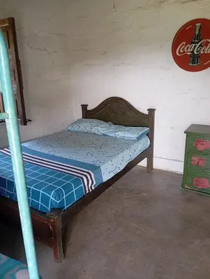 a bedroom with a bunk bed with a blue comforter at La Luna cabin in Amagá