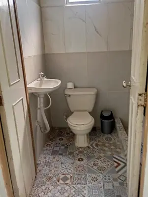 a bathroom with a toilet and a sink at La Luna cabin in Amagá