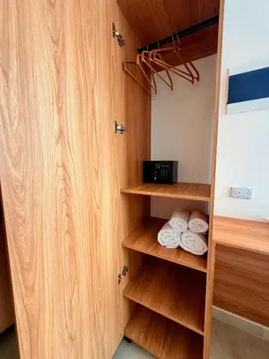 a closet with wooden shelves and towels at Lujoso y cómodo Loft en Laureles in Medellín