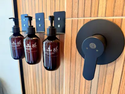 a wall with three bottles of soap on a door at Lujoso y cómodo Loft en Laureles in Medellín